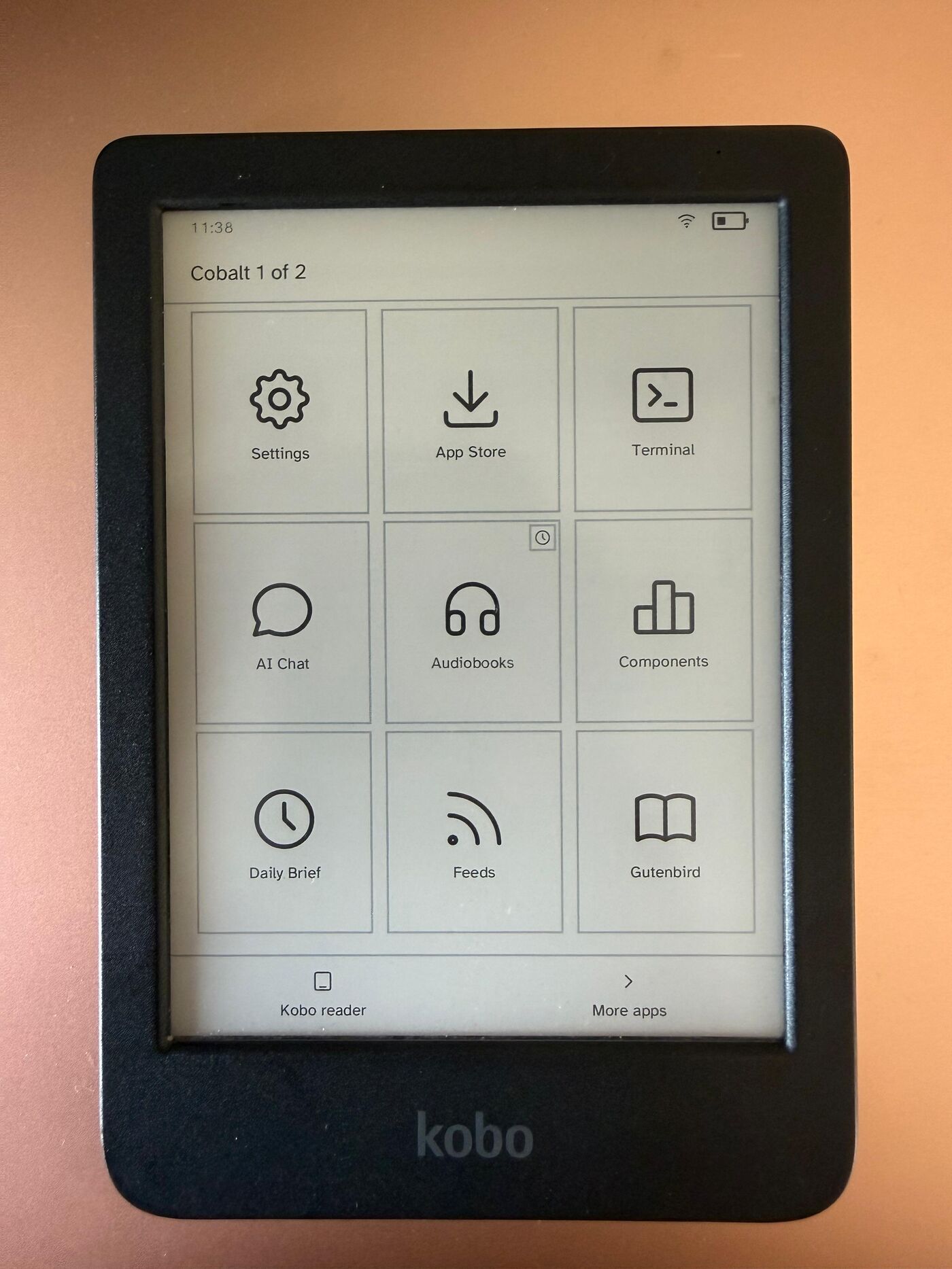The Cobalt launcher on a Kobo Clara BW showing Settings, App Store, Terminal, AI Chat, Audiobooks, Components, Daily Brief, Feeds and Gutenbird